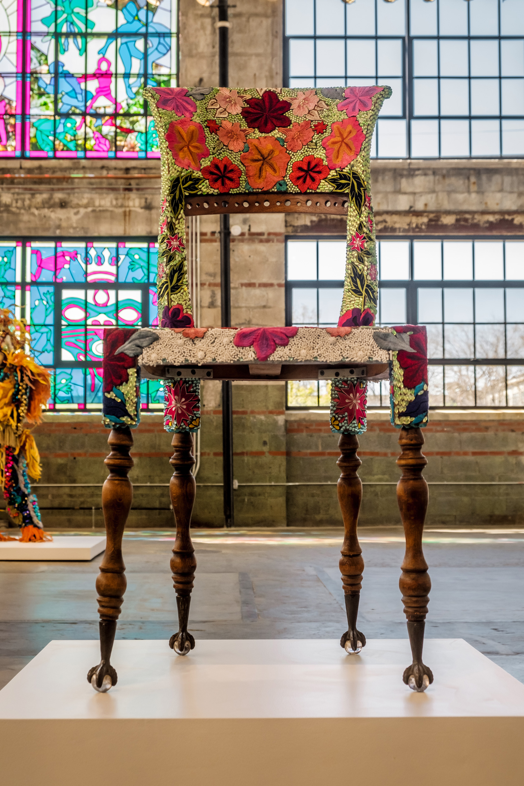 wooden chair covered with a beaded design