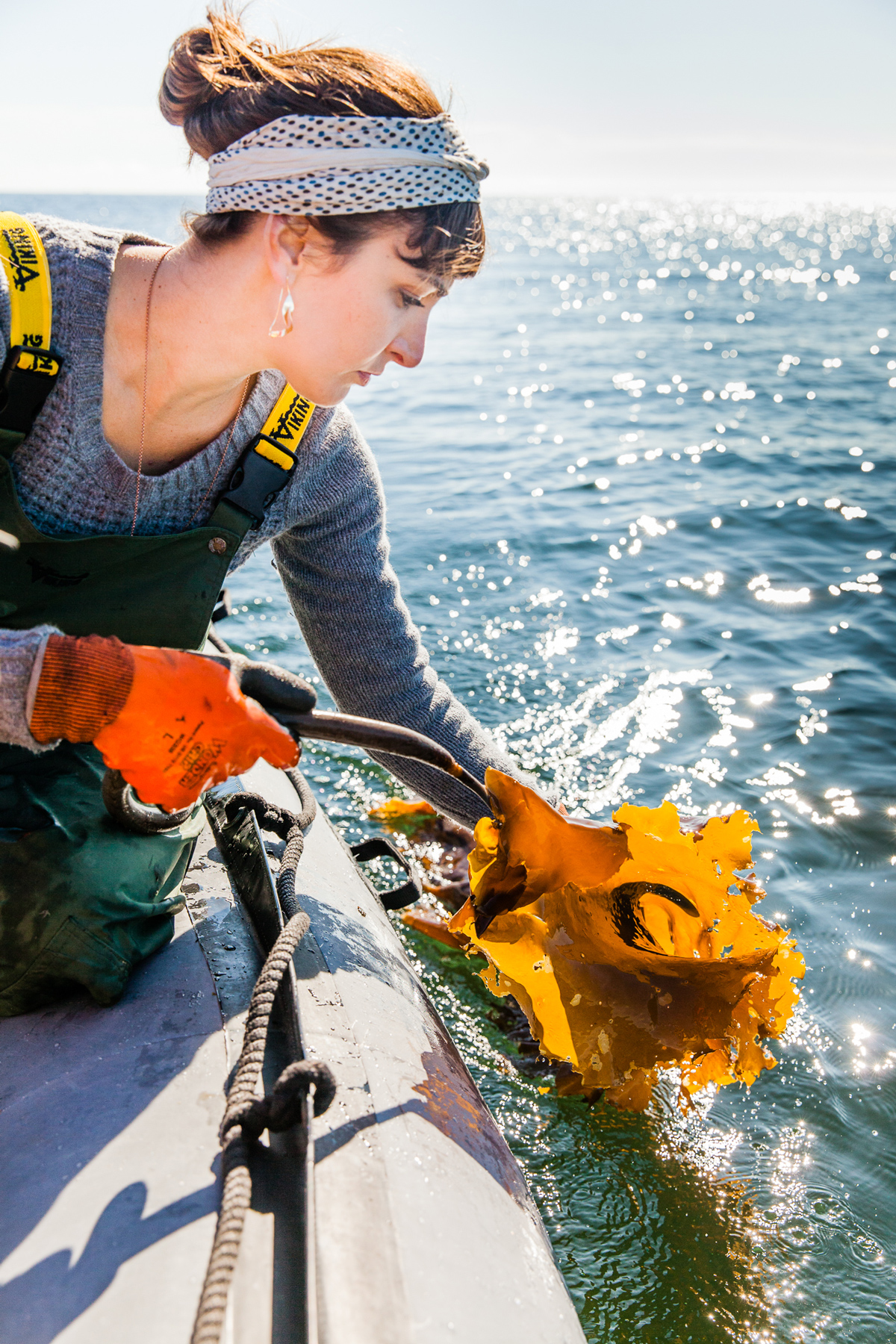 woman on a boat assisting with kelp farming